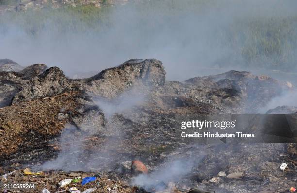 Smoke rising from garbage set on fire in the Ghaziabad Wave City area is polluting the environment on March 27, 2024 in Ghaziabad, India.