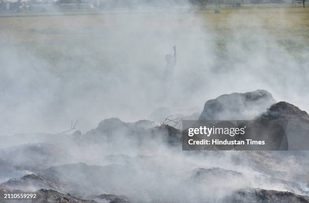 Smoke rising from garbage set on fire in the Ghaziabad Wave City area is polluting the environment on March 27, 2024 in Ghaziabad, India.