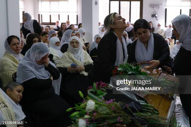 Women gather around casket of Zaher Bishara, a Druze man from the village of Ein Qiniyya in the Israel-annexed Golan heights, killed in an industrial...