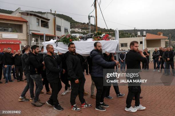 Mourners carry the casket of Zaher Bishara, a Druze man from the village of Ein Qiniyya in the Israel-annexed Golan heights, killed in an industrial...