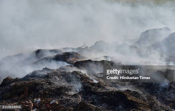 Smoke rising from garbage set on fire in the Ghaziabad Wave City area is polluting the environment on March 27, 2024 in Ghaziabad, India.
