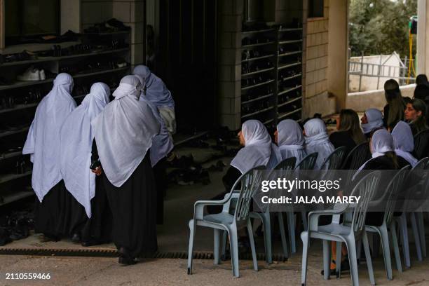 Women attend the funeral of Zaher Bishara, a Druze man from the village of Ein Qiniyya in the Israel-annexed Golan heights, killed in an industrial...