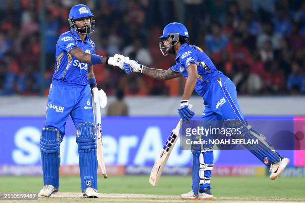 Mumbai Indians' captain Hardik Pandya and Tilak Varma bump their fists during the Indian Premier League Twenty20 cricket match between Sunrisers...