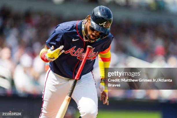 Ronald Acuña Jr. #13 of the Atlanta Braves flips his bat after hitting an RBI single in the fifth inning during a Grapefruit League spring training...