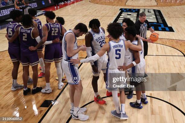 Duke Blue Devils players huddle during the second half against the James Madison Dukes in the second round of the NCAA Men's Basketball Tournament at...