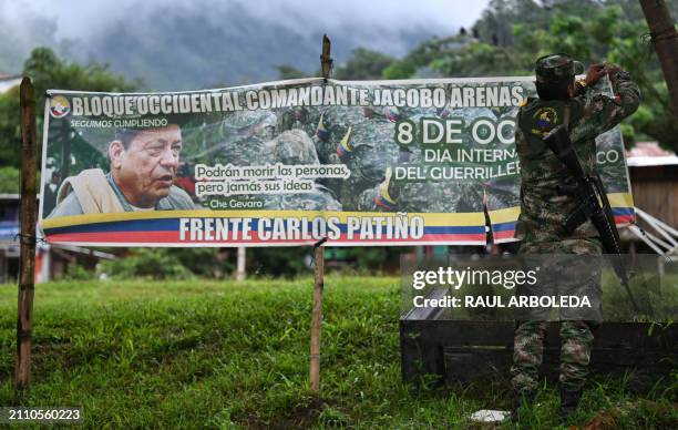 Member of the Carlos Patino front of the dissident FARC guerrilla hangs up a banner in Micay Canyon, a mountainous area and EMC stronghold in Cauca...