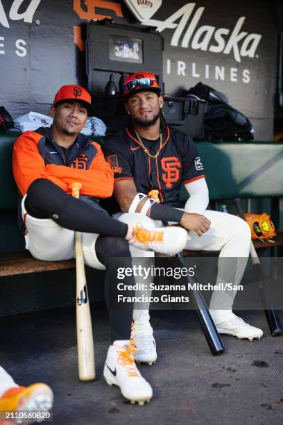 Ismael Munguia and Luis Matos sit in the dugout at Oracle Park on March 26, 2024 in San Francisco, California.