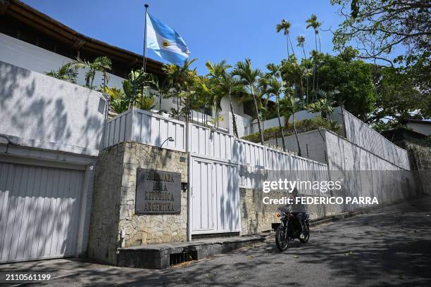 Motorcyclist rides past the residence of Argentina's ambassador in Caracas on March 27, 2024. The Argentine ambassador's residence in Caracas is...