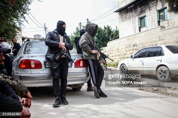 Armed men participate in the funeral of 3 Palestinian youths who were killed by Israeli forces' bullets during a raid on the Damj neighborhood in...