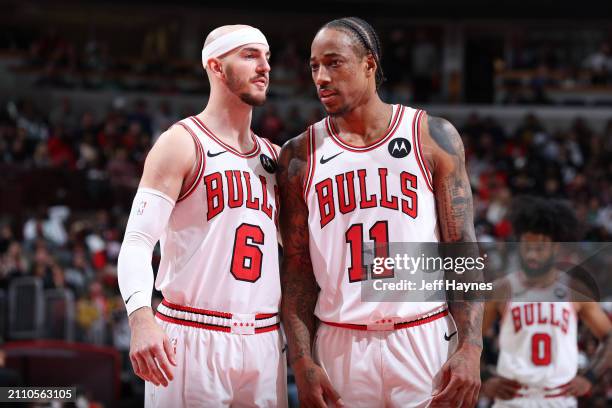 Alex Caruso and DeMar DeRozan of the Chicago Bulls looks on during the game against the Boston Celtics on March 23, 2024 at United Center in Chicago,...
