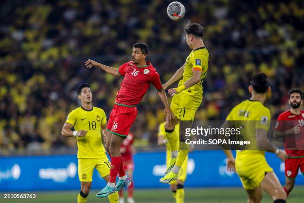 Mohammad Mubarak Al Ghafri and Dion Cools of Malaysia in action during the 2026 World Cup/2027 Asian Cup Qualifiers Group D match between Malaysia...