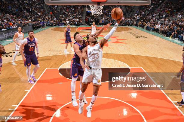 Tre Jones of the San Antonio Spurs drives to the basket during the game against the Phoenix Suns on March 25, 2024 at the AT&T Center in San Antonio,...