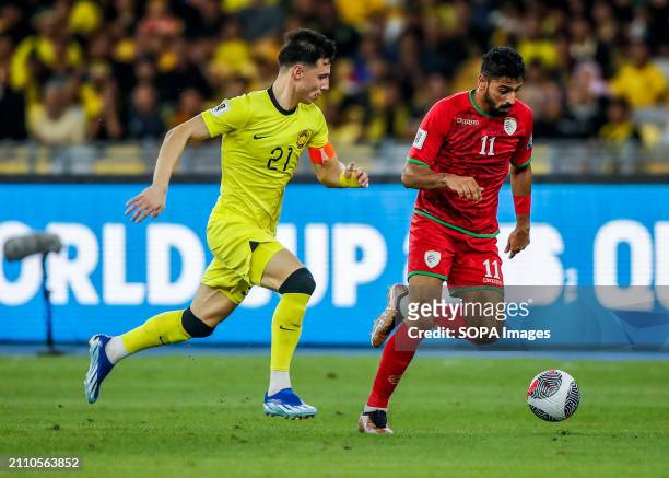 Dion Cools of Malaysia and Muhsen Saleh Al Ghassani of Oman in action during the 2026 World Cup/2027 Asian Cup Qualifiers Group D match between...