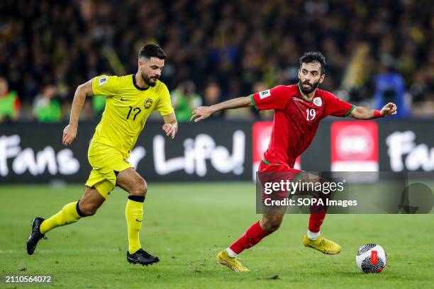 Paulo Josue of Malaysia and Hatem Al Rushadi of Oman in action during the 2026 World Cup/2027 Asian Cup Qualifiers Group D match between Malaysia and...