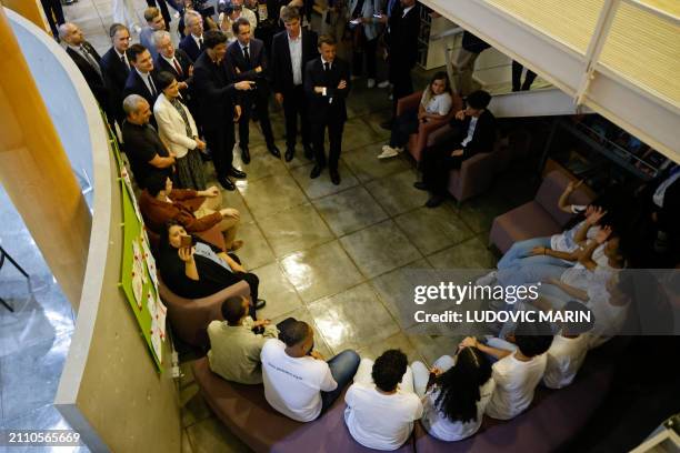 France's President Emmanuel Macron , Carrefour's CEO Alexandre Bompard and Brazilian former football player Rai Souza Vieira de Oliveira attend a...