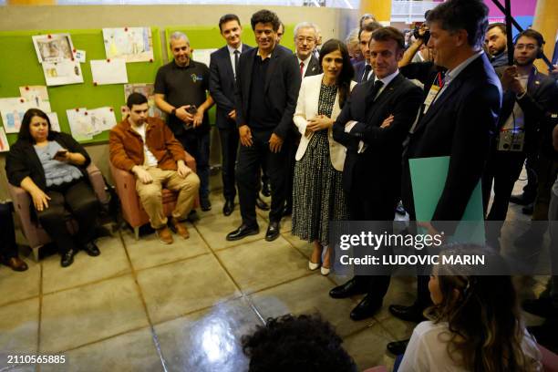 France's President Emmanuel Macron and Brazilian former football player Rai Souza Vieira de Oliveira attend a meeting with members of the Gol de...