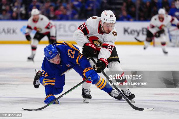 Erik Brannstrom of the Ottawa Senators battles for the puck against Jack Quinn of the Buffalo Sabres during an NHL game on March 27, 2024 at KeyBank...