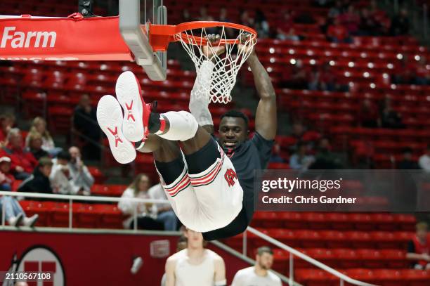 Keba Keita of the Utah Utes swings on the rim during warmups before their game agianst the VCU Rams in the quarterfinals of the NIT Mens Basketball...