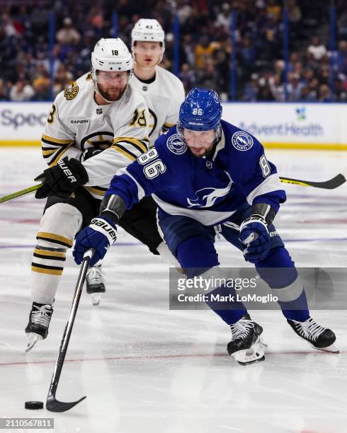 Nikita Kucherov of the Tampa Bay Lightning against Pavel Zacha of the Boston Bruins during the second period at Amalie Arena on March 27, 2024 in...