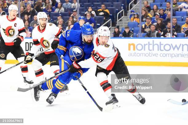 Jordan Greenway of the Buffalo Sabres is defended by Erik Brannstrom of the Ottawa Senators during an NHL game on March 27, 2024 at KeyBank Center in...