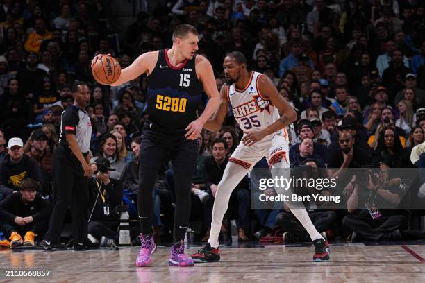 Kevin Durant of the Phoenix Suns plays defense during the game against Nikola Jokic of the Denver Nuggets on March 27, 2024 at the Ball Arena in...