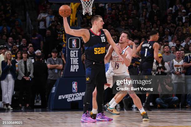 Drew Eubanks of the Phoenix Suns plays defense during the game against Nikola Jokic of the Denver Nuggets on March 27, 2024 at the Ball Arena in...