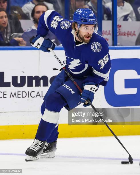 Brandon Hagel of the Tampa Bay Lightning against Brandon Carlo of the Boston Bruins during the third period at Amalie Arena on March 27, 2024 in...