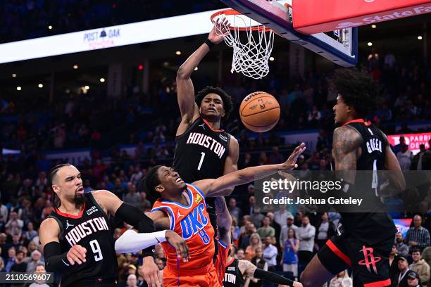 Jalen Williams of the Oklahoma City Thunder puts up a shot against Dillon Brooks, Amen Thompson and Jalen Green of the Houston Rockets during the...