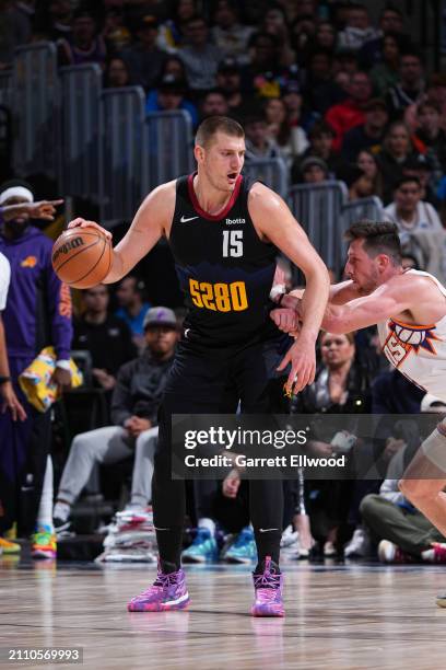 Nikola Jokic of the Denver Nuggets handles the ball during the game against the Phoenix Suns on March 27, 2023 at the Ball Arena in Denver, Colorado....