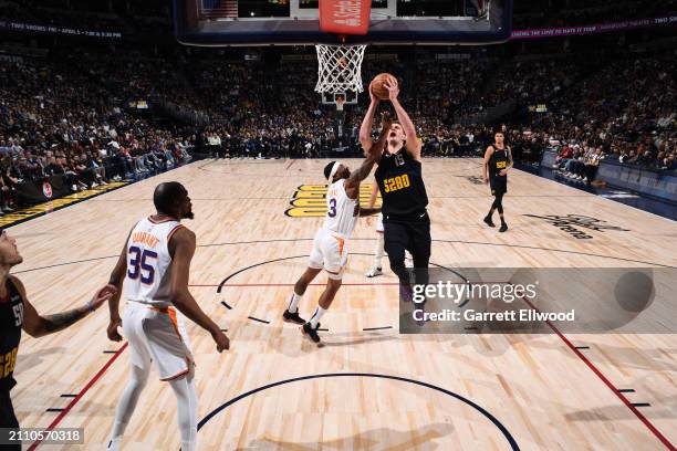 Nikola Jokic of the Denver Nuggets drives to the basket during the game against the Phoenix Suns on March 27, 2023 at the Ball Arena in Denver,...