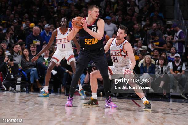 Drew Eubanks of the Phoenix Suns plays defense during the game against Nikola Jokic of the Denver Nuggets on March 27, 2024 at the Ball Arena in...