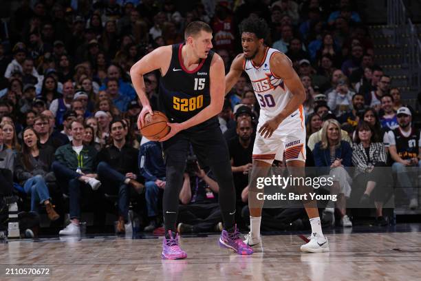 Thaddeus Young of the Phoenix Suns plays defense during the game against Nikola Jokic of the Denver Nuggets on March 27, 2024 at the Ball Arena in...