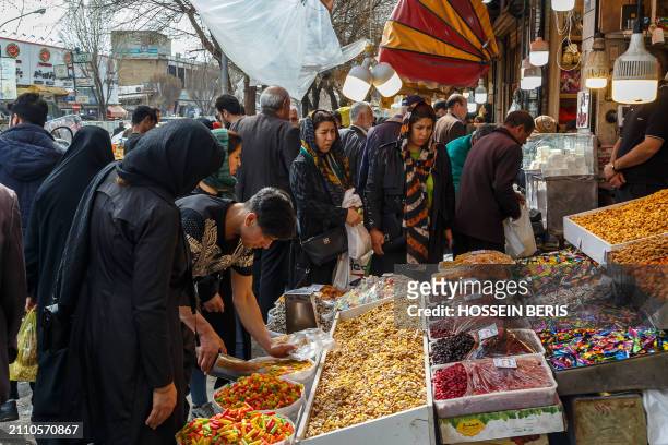 Iranian people purchase items to prepare for the approaching Persian New Year, Nowruz, at the Tehran Grand Bazaar on March 17, 2024. Nowruz, which...