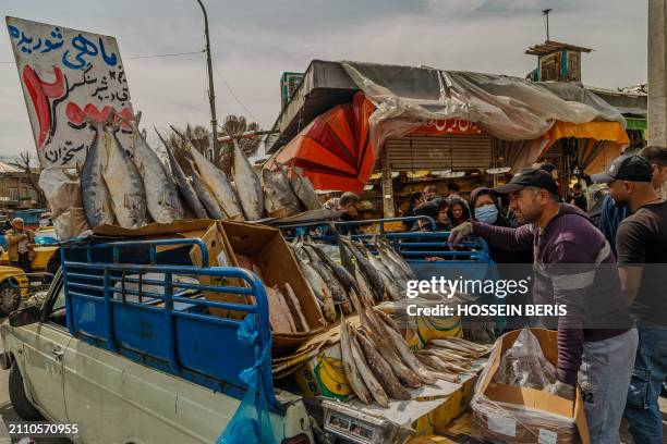 Iranian people purchase items to prepare for the approaching Persian New Year, Nowruz, at the Tehran Grand Bazaar on March 17, 2024. Nowruz, which...