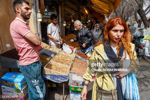 Iranian people purchase items to prepare for the approaching Persian New Year, Nowruz, at the Tehran Grand Bazaar on March 17, 2024. Nowruz, which...
