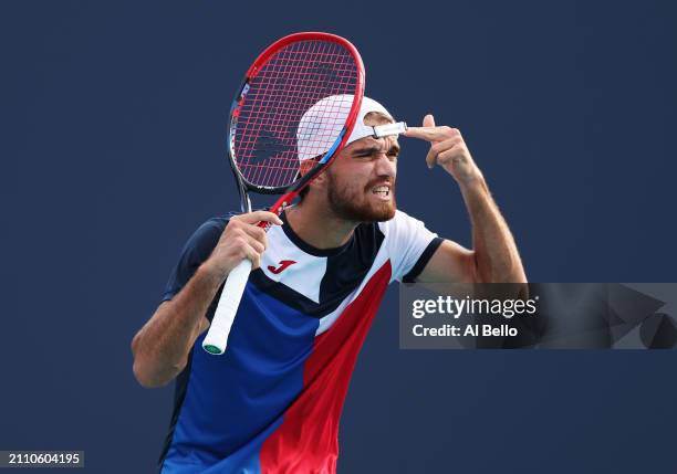 Tomas Machac of the Czech Republic reacts to a lost point against Andy Murray of Great Britain on Day 9 of the Miami Open at Hard Rock Stadium on...