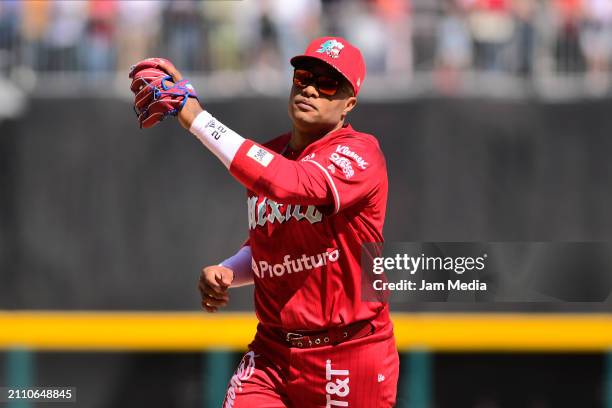 Robinson Cano of Diablos Rojos del Mexico throws the ball in the second inning during Spring Training Game One between Diablos Rojos and New York...