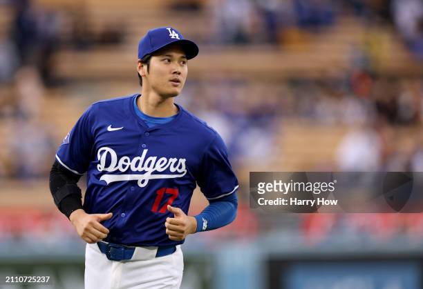 Shohei Ohtani of the Los Angeles Dodgers warms up before a preseason game against the Los Angeles Angels at Dodger Stadium on March 24, 2024 in Los...