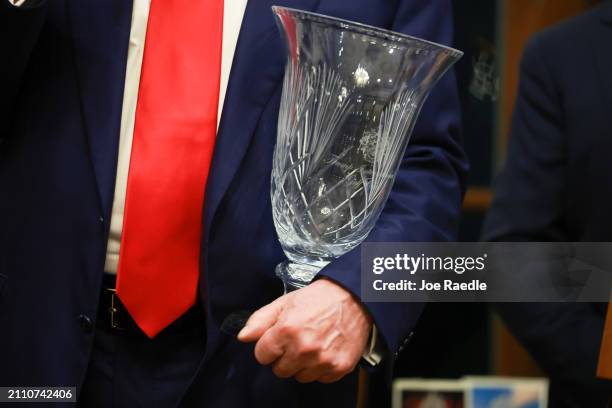 Republican presidential candidate and former President Donald Trump holds the 2024 Trump International Golf Club Most Improved Player award given to...