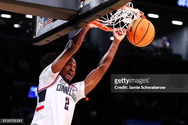Tristen Newton of the Connecticut Huskies dunks the ball during the second half of the game against the Northwestern Wildcats during the second round...