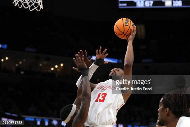 Wan Roberts of the Houston Cougars shoots the ball against Tyrece Radford of the Texas A&M Aggies during the second half in the second round of the...