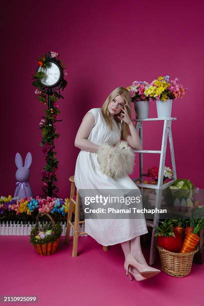 elegant woman  wearing white dress - giant rabbit stock pictures, royalty-free photos & images