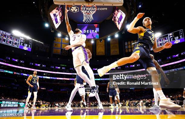 Anthony Davis of the Los Angeles Lakers takes a shot against Andrew Nembhard of the Indiana Pacers in the first half at Crypto.com Arena on March 24,...
