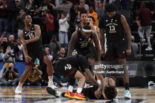 Teammates celebrate with Andersson Garcia of the Texas A&M Aggies after he made the game tying shot against the Houston Cougars at the end of...