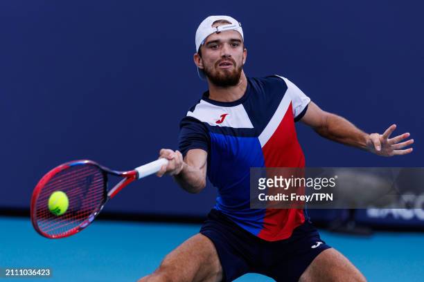 Tomas Machac of the Czech Republic hits a forehand against Andy Murray of Great Britain in the third round of the Miami Open at the Hard Rock Stadium...