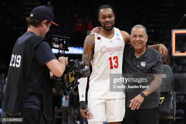 Wan Roberts and head coach Kelvin Sampson of the Houston Cougars embrace following their team's victory against the Texas A&M Aggies in the second...