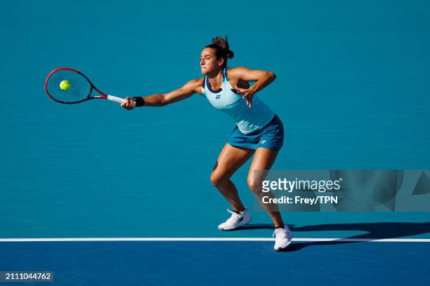 Caroline Garcia of France hits a forehand against Naomi Osaka of Japan in the third round of the Miami Open at the Hard Rock Stadium on March 24,...