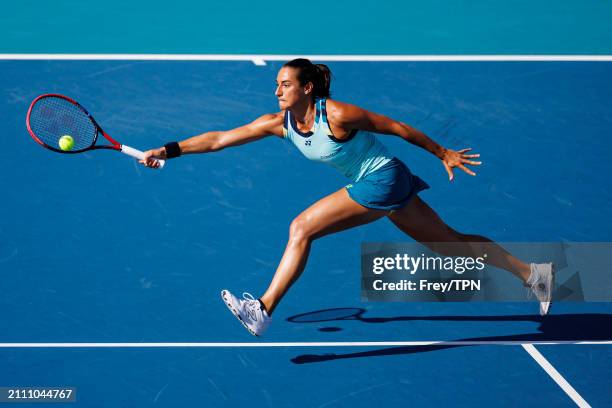 Caroline Garcia of France hits a forehand against Naomi Osaka of Japan in the third round of the Miami Open at the Hard Rock Stadium on March 24,...