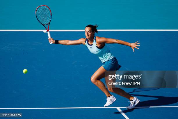 Caroline Garcia of France hits a forehand against Naomi Osaka of Japan in the third round of the Miami Open at the Hard Rock Stadium on March 24,...