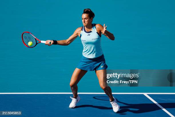 Caroline Garcia of France hits a forehand against Naomi Osaka of Japan in the third round of the Miami Open at the Hard Rock Stadium on March 24,...